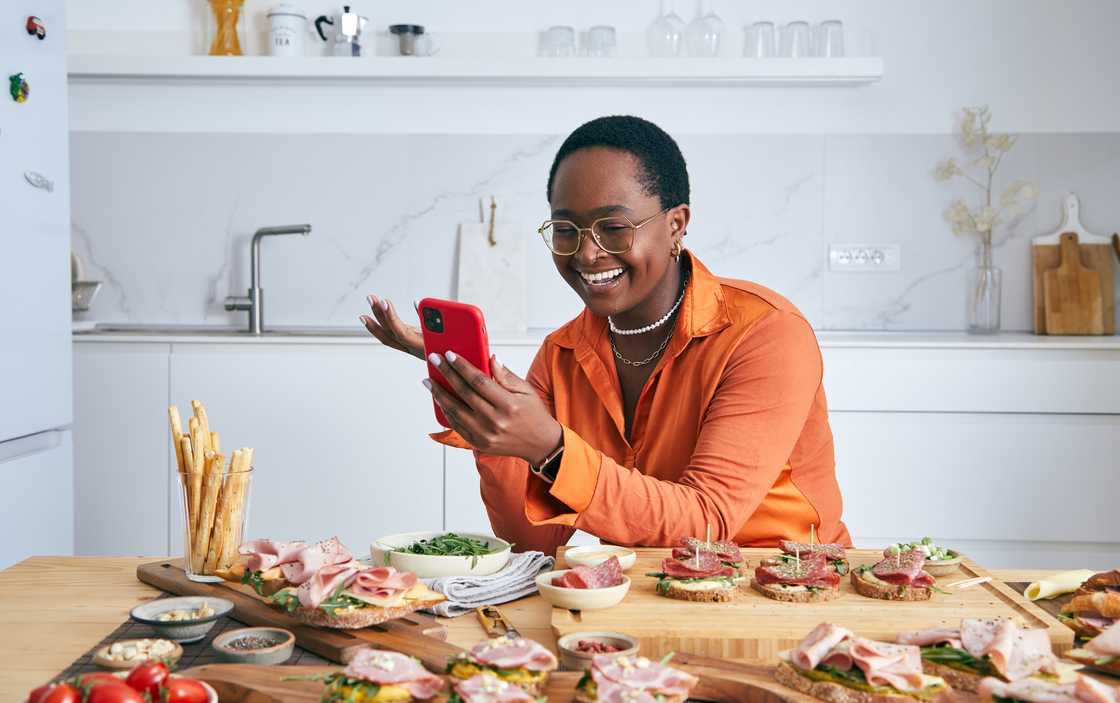 A girl cooking while making a video call.