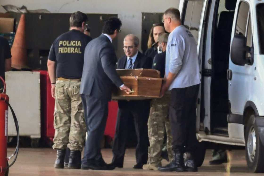 One of the coffins containing human remains found during the search for British journalist Dom Phillips and indigenous expert Bruno Pereira in the Amazon is carried at a police hangar in Brasilia, on June 23, 2022 One of the coffins containing human remains found during the search for British journalist Dom Phillips and indigenous expert Bruno Pereira in the Amazon is carried at a police hangar in Brasilia, on June 23, 2022