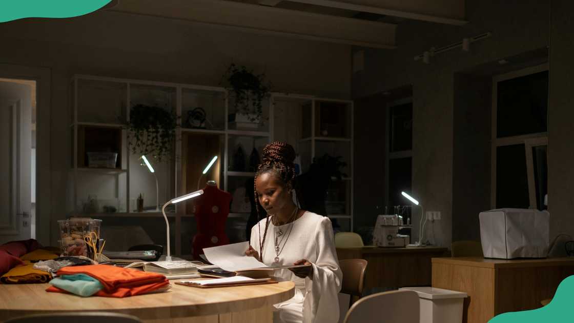 A fashion designer working late in the sewing work space