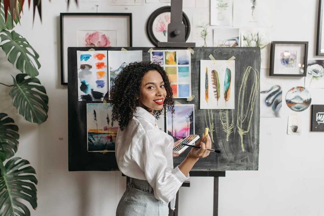 A woman painting in a small art studio. A woman painting in a small art studio.