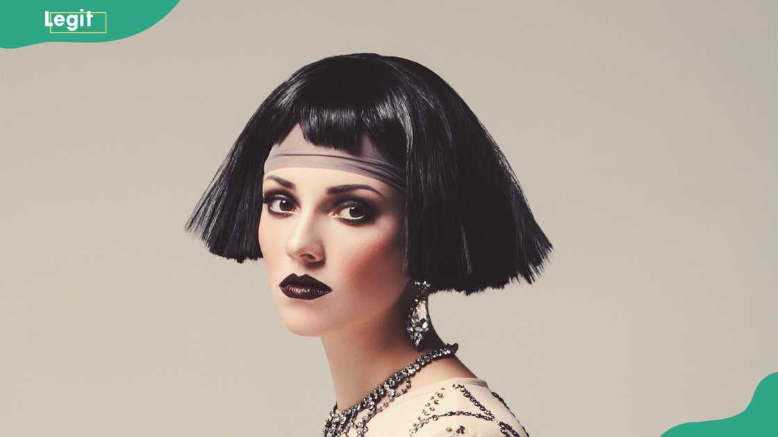 A stunning woman in 1920s style, deep kohl-lined eyes A stunning woman in 1920s style, deep kohl-lined eyes