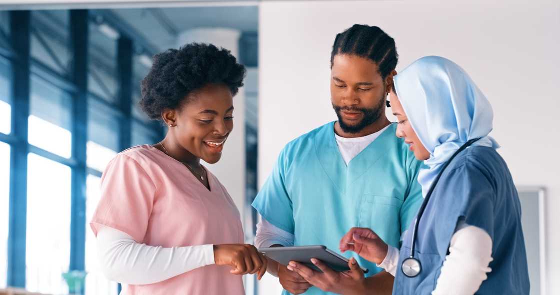 Medical students working on a medical report Medical students working on a medical report