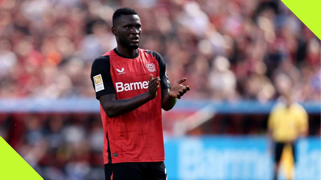 Victor Boniface applauding Bayer Leverkusen fans.