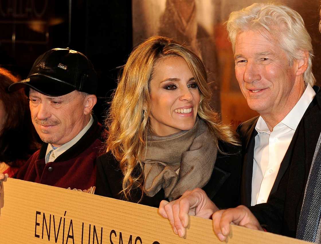 Richard Gere and Alejandra Silva hold up a campaign sign