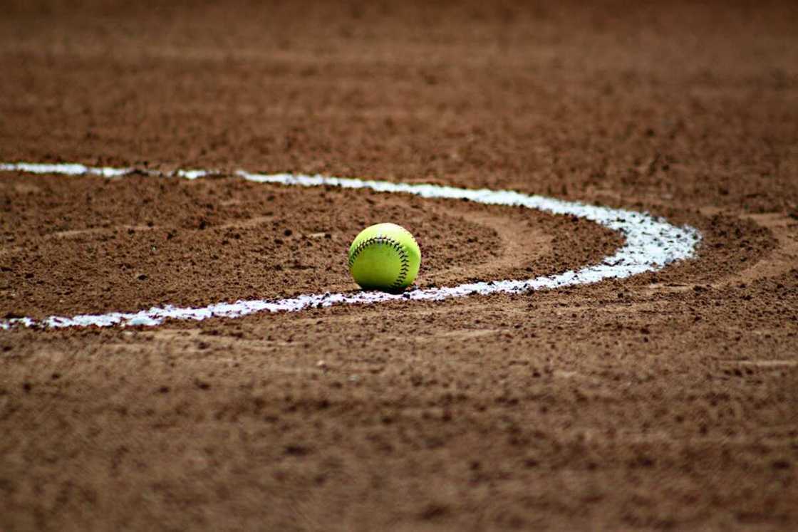 A softball on the ground