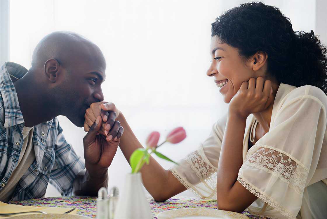 Man kissing a hand of a girl