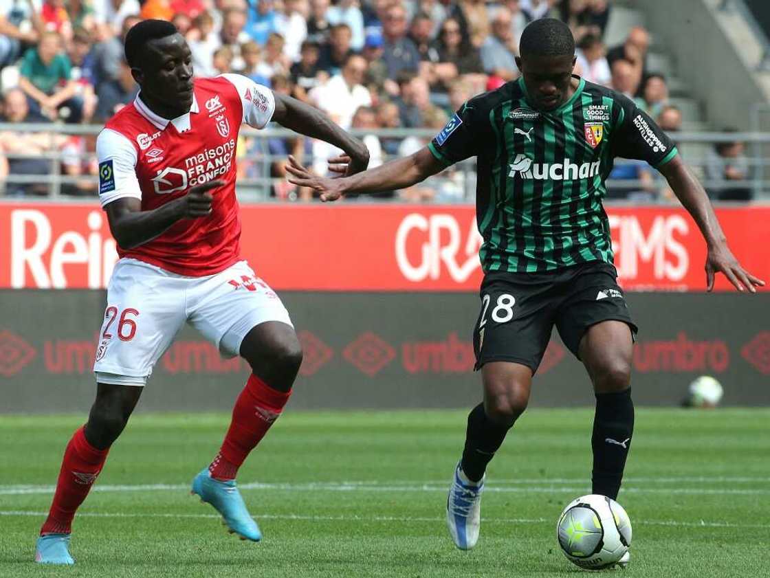 Malian defender Cheick Doucoure (R) is leaving Lens to join Crystal Palace in the English Premier League