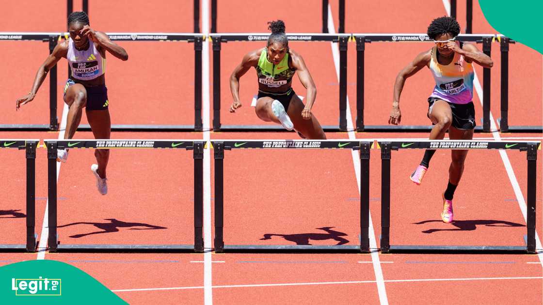 Tobi Amusan, Masai Russell of the United States, and Devynne Charlton of the Bahamas compete in the Women's 100m Hurdles the 2026 Diamond League in Eugene. Photo by Ali Gradischer