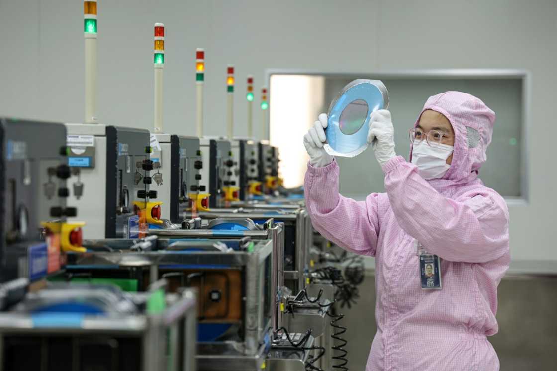 A worker examines semiconductor chips for export at a factory in Binzhou, Shandong province