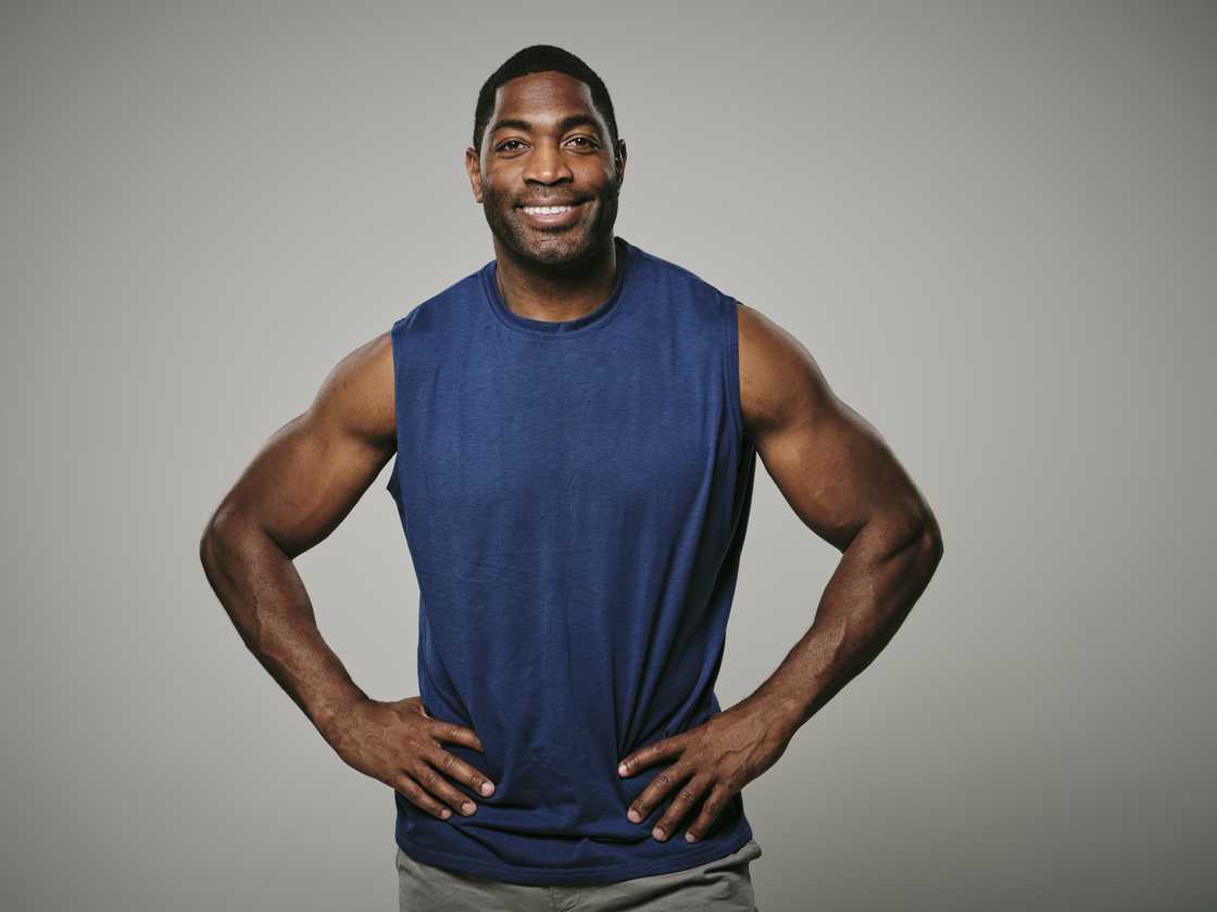 A man wearing a dark blue tank top.