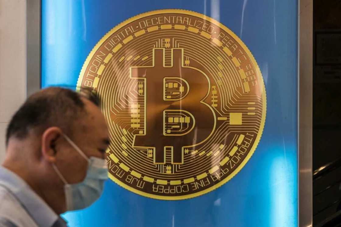 A man walks past a bitcoin poster in Hong Kong on April 15, 2024 A man walks past a bitcoin poster in Hong Kong on April 15, 2024