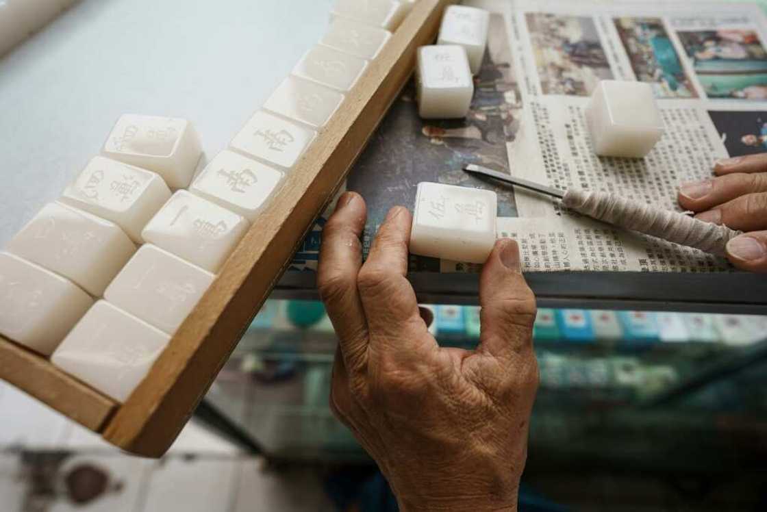 Handcrafted mahjong tile sets cost more than twice as much as those carved by machines Handcrafted mahjong tile sets cost more than twice as much as those carved by machines
