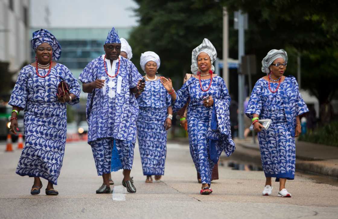 Yoruba tribe members walking in unison. Yoruba tribe members walking in unison.