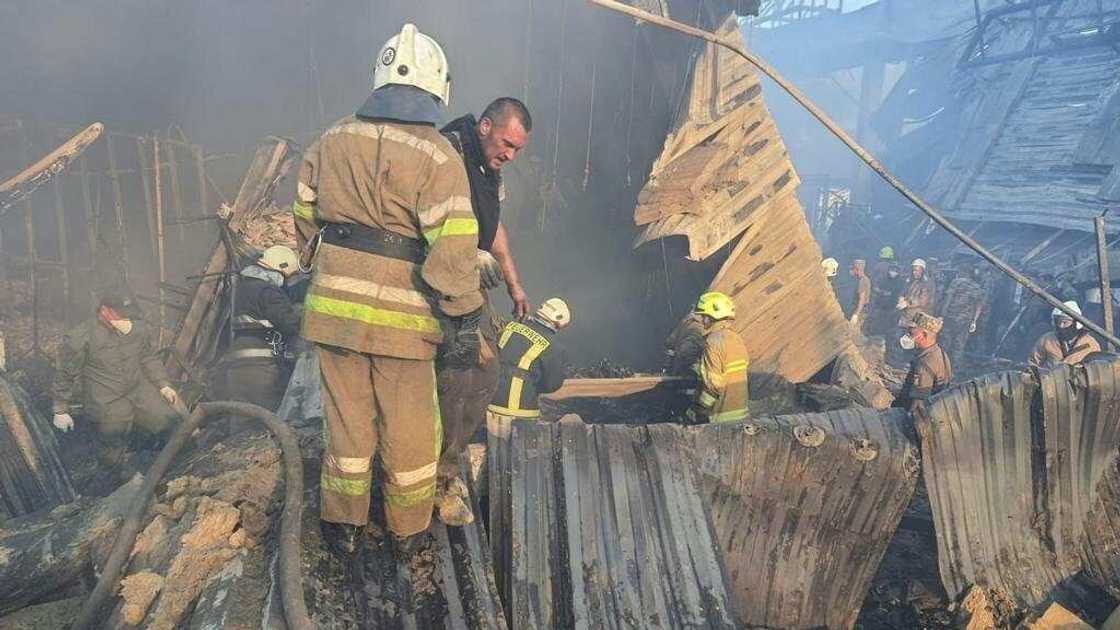 Rescue personnel work amid the smouldering remains of the mall in Kremenchuk Rescue personnel work amid the smouldering remains of the mall in Kremenchuk