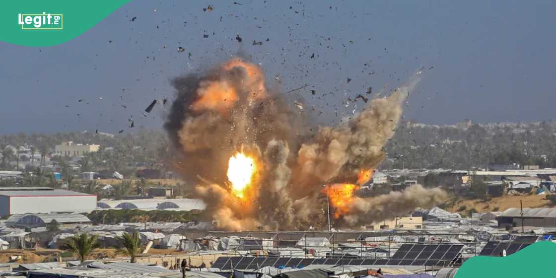 Smoke and fire rise from a shelter housing after an Israeli air strike. Smoke and fire rise from a shelter housing after an Israeli air strike.