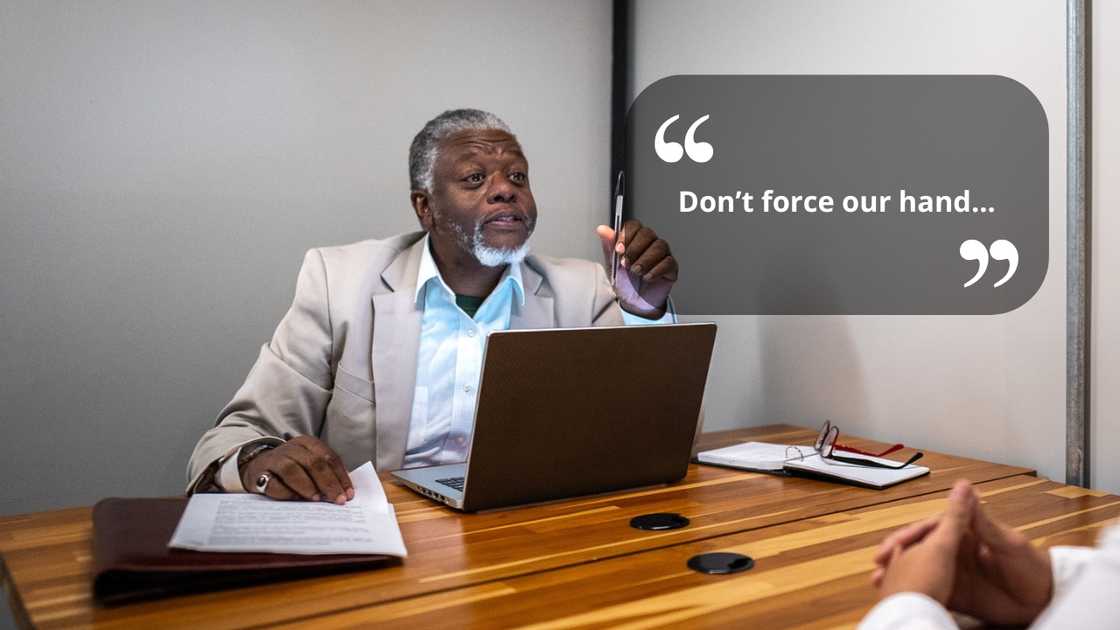 A seious councillor talking to someone in the office