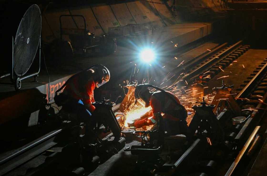 Maintenance staff have to be quick to finish before trains start up again at dawn Maintenance staff have to be quick to finish before trains start up again at dawn