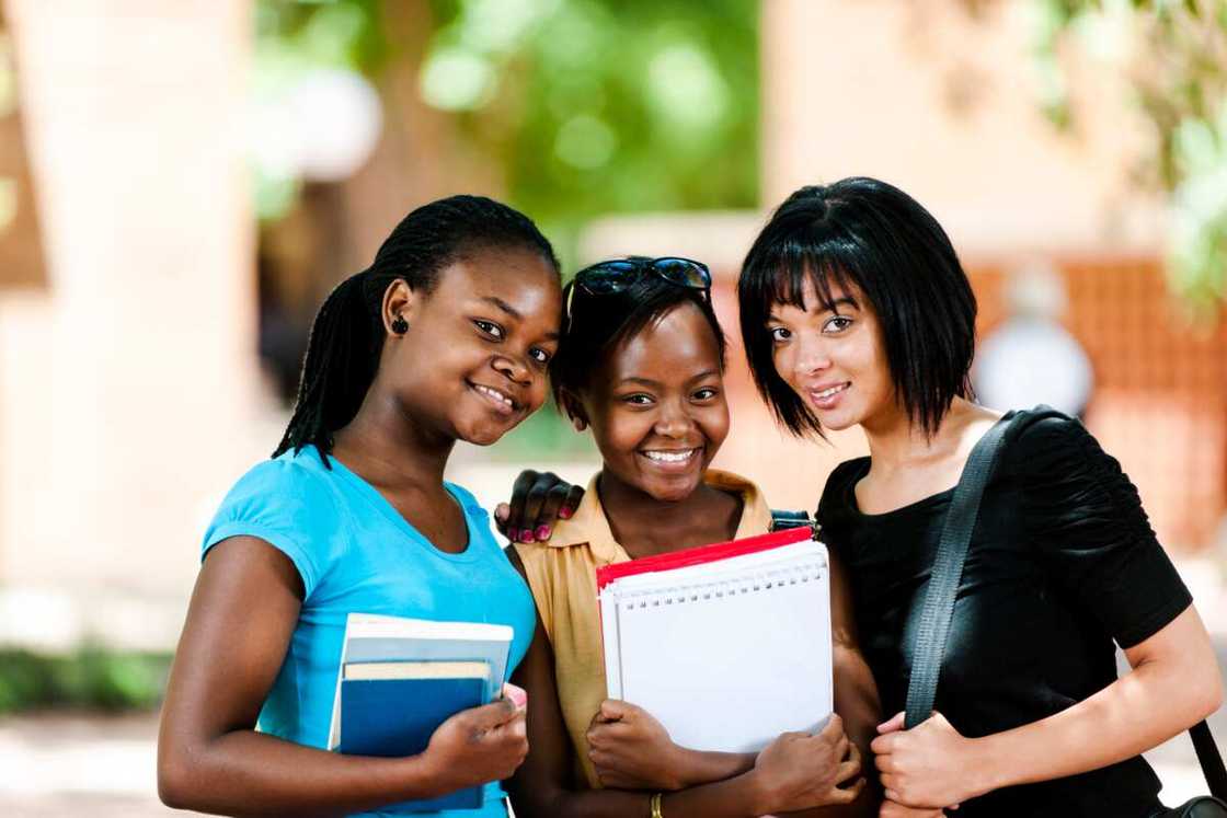 Group of female students together in campus Group of female students together in campus