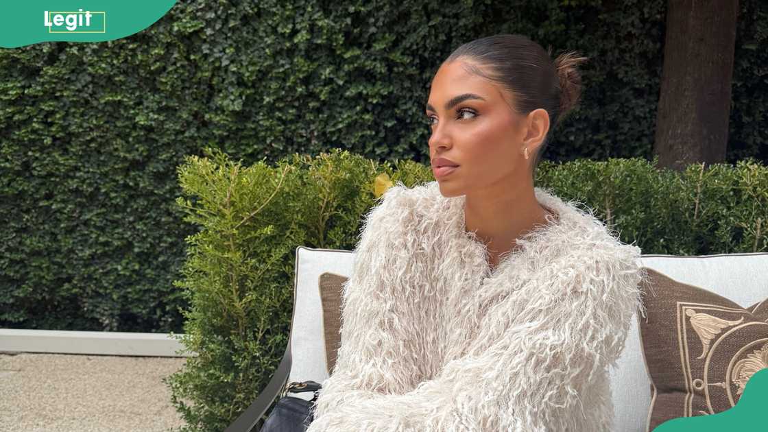 Donna Dafi in a backyard setting with throw pillows and greenery