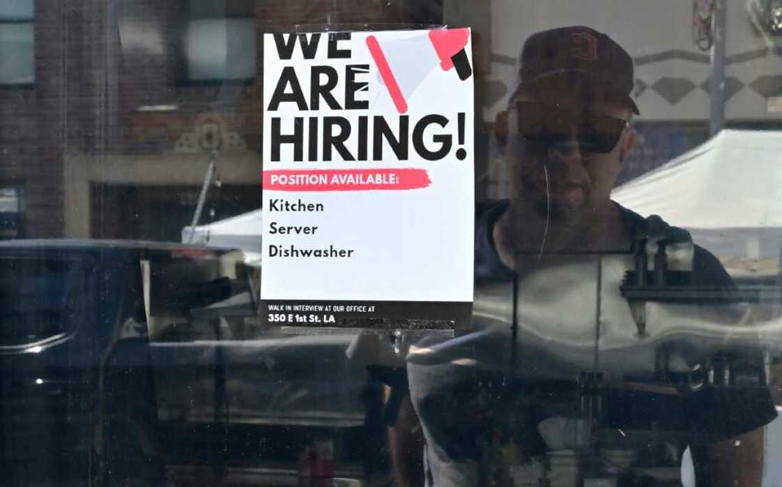 A 'We Are Hiring' sign is seen in front of a restaurant in Los Angeles, California in August 2022