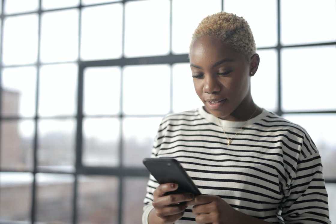 A young woman using her phone to text