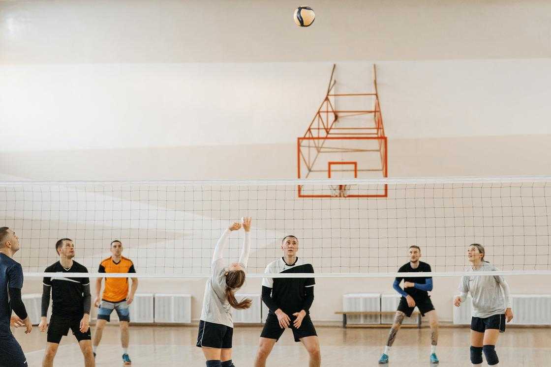 Group of people wearing sportswear playing volleyball Group of people wearing sportswear playing volleyball