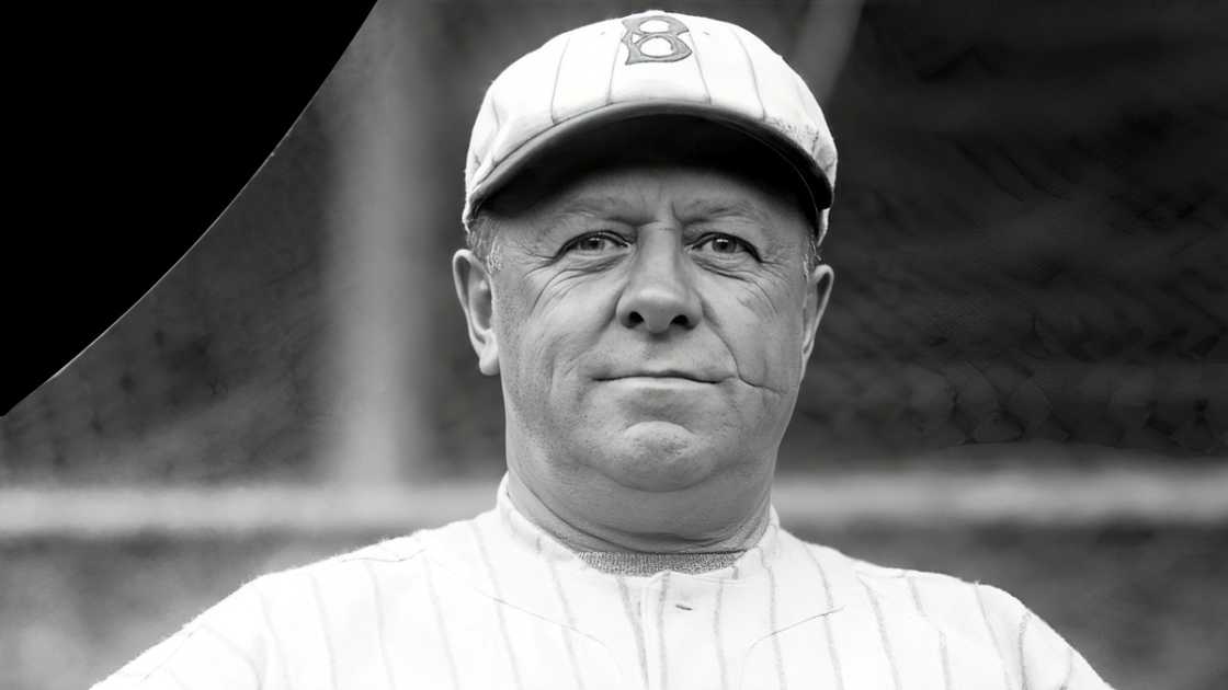 Wilbert Robinson poses standing wearing the Brooklyn Dodgers kit.