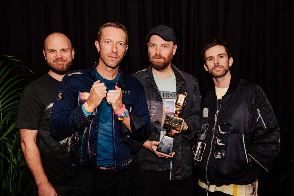Coldplay band members at an award ceremony Coldplay band members at an award ceremony