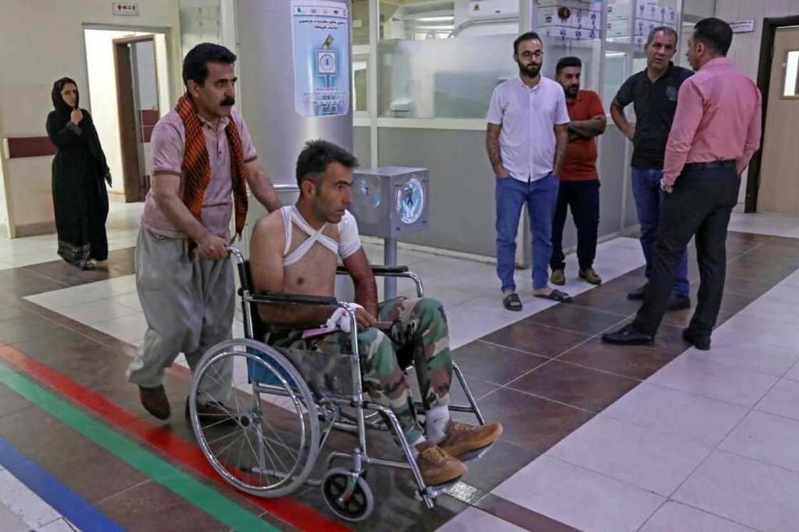 A wounded manat a hospital following strikes by Iran on the village of Altun Kupri, south of the capital Arbil, in Iraq's autonomous Kurdistan region on September 28, 2022