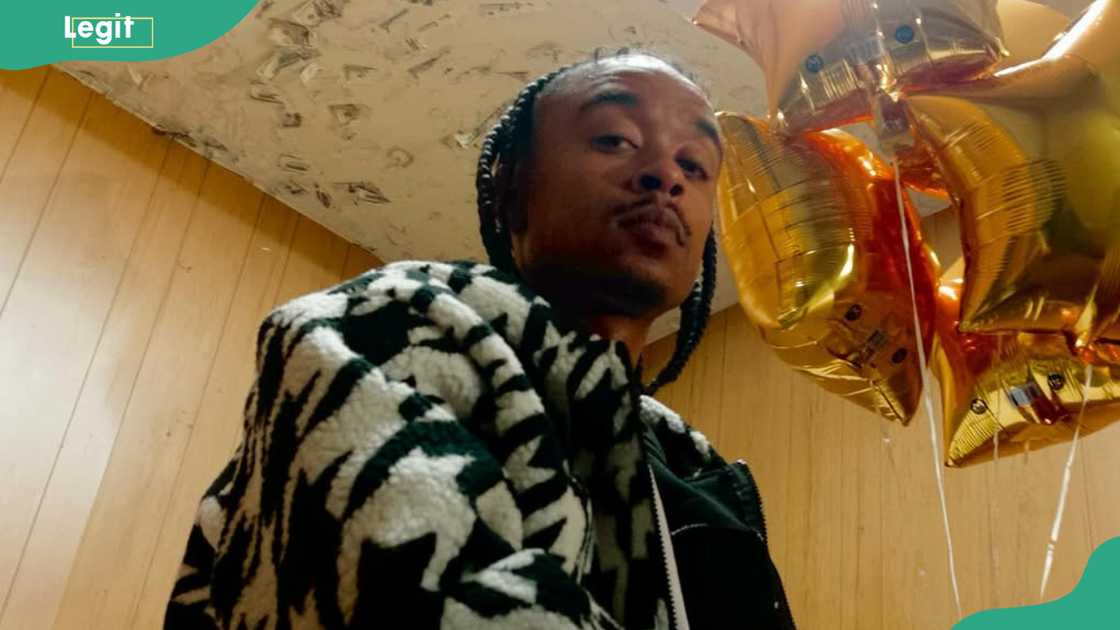 Rapper K.A.A.N. looks as he stands next to golden balloons. Rapper K.A.A.N. looks as he stands next to golden balloons.