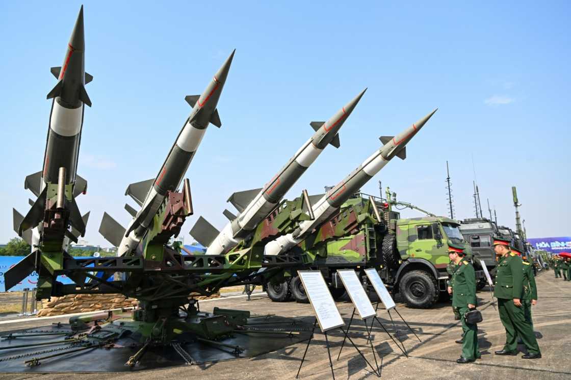 Vietnamese military officials look at an anti-aircraft missile launcher and ammunition during a defence expo in Hanoi Vietnamese military officials look at an anti-aircraft missile launcher and ammunition during a defence expo in Hanoi