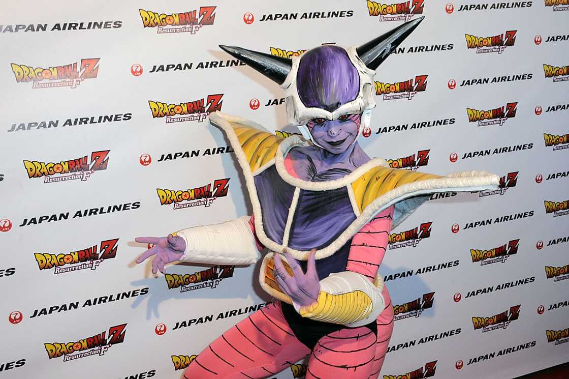 A cosplayer in a full purple and white Frieza costume posing in front of a Dragon Ball Z backdrop at the Egyptian Theatre in Hollywood, 2015 A cosplayer in a full purple and white Frieza costume posing in front of a Dragon Ball Z backdrop at the Egyptian Theatre in Hollywood, 2015