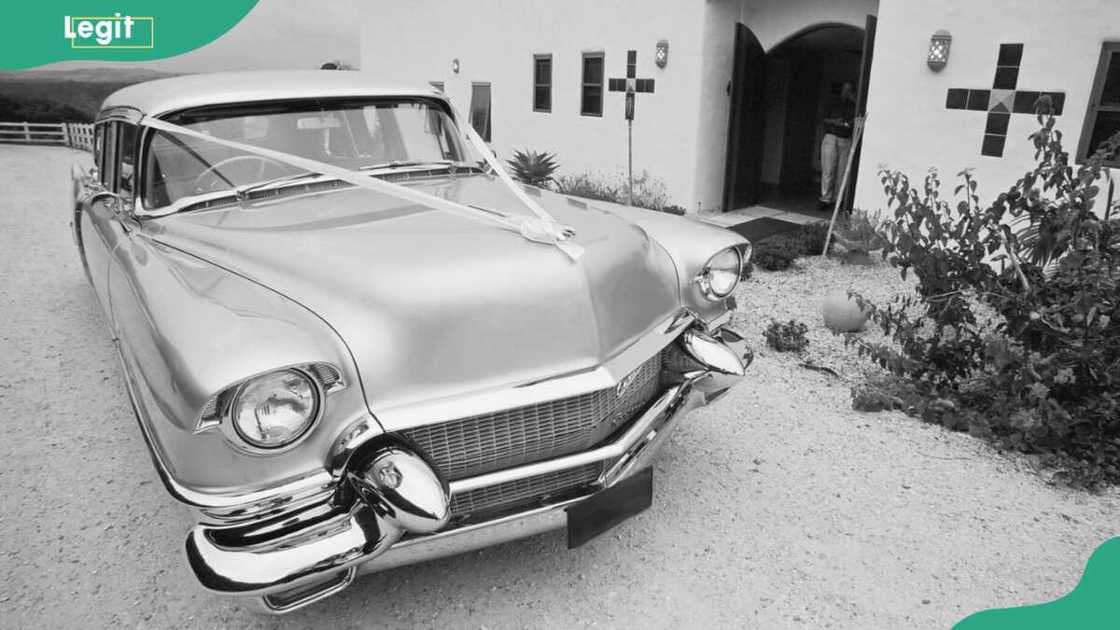 Cadillac wedding car outside Mexican style building Cadillac wedding car outside Mexican style building