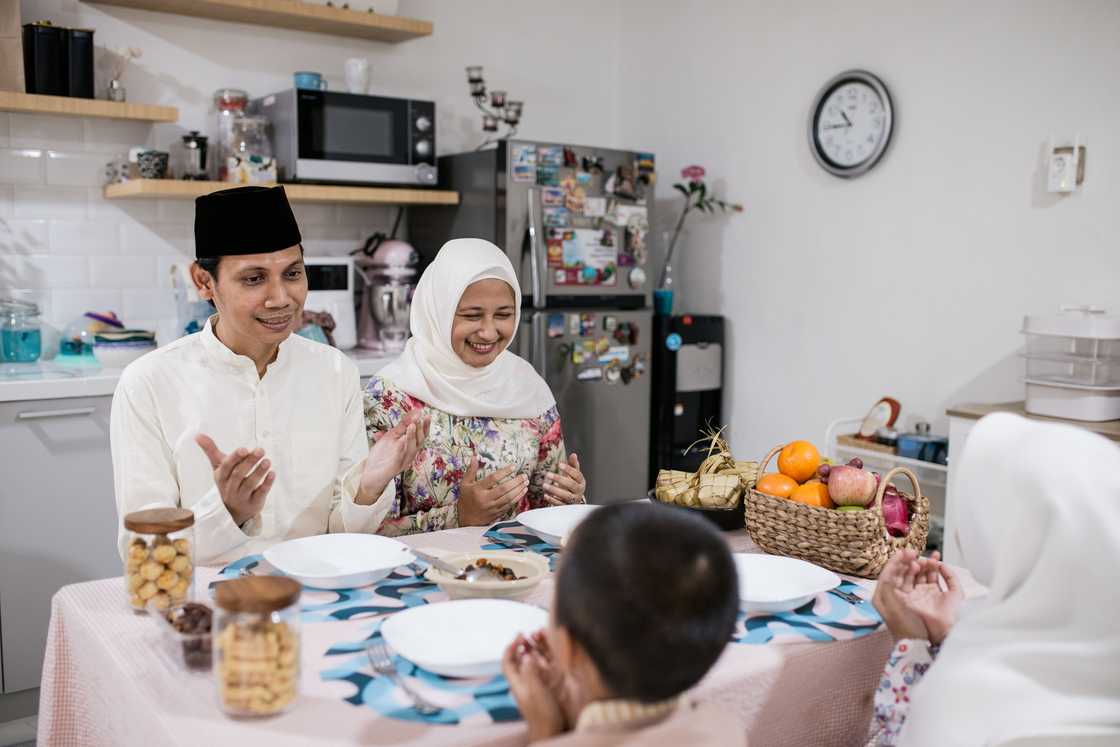 An Indonesian family celebrating Eid al-Fitr at their home. An Indonesian family celebrating Eid al-Fitr at their home.