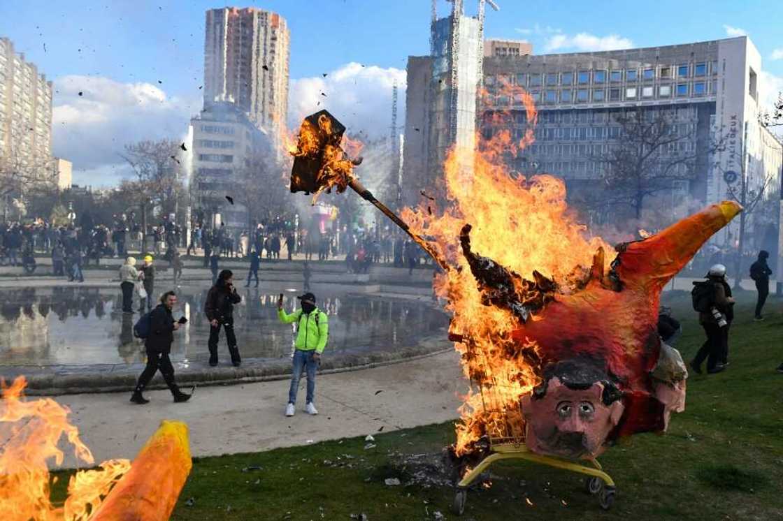 Demonstrators burn an effigy of Macron during a pensions protest in Paris on April 6 Demonstrators burn an effigy of Macron during a pensions protest in Paris on April 6