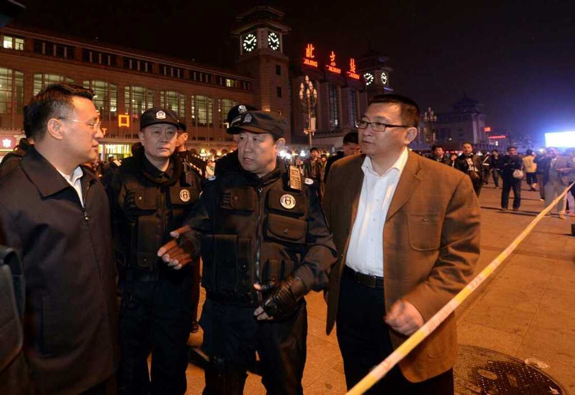 This picture, taken on May 6, 2014, shows then Chinese deputy minister of public security Fu Zhenghua (C) speaking at Beijing railway station