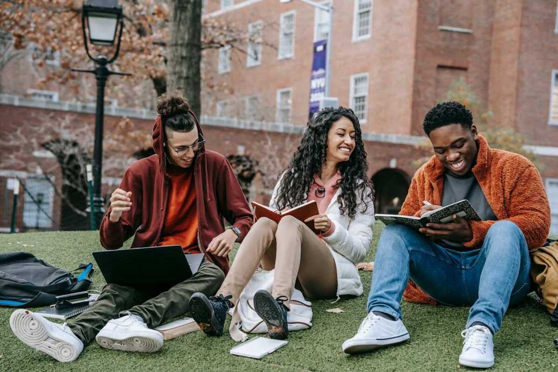 Three student studying outside classroom Three student studying outside classroom
