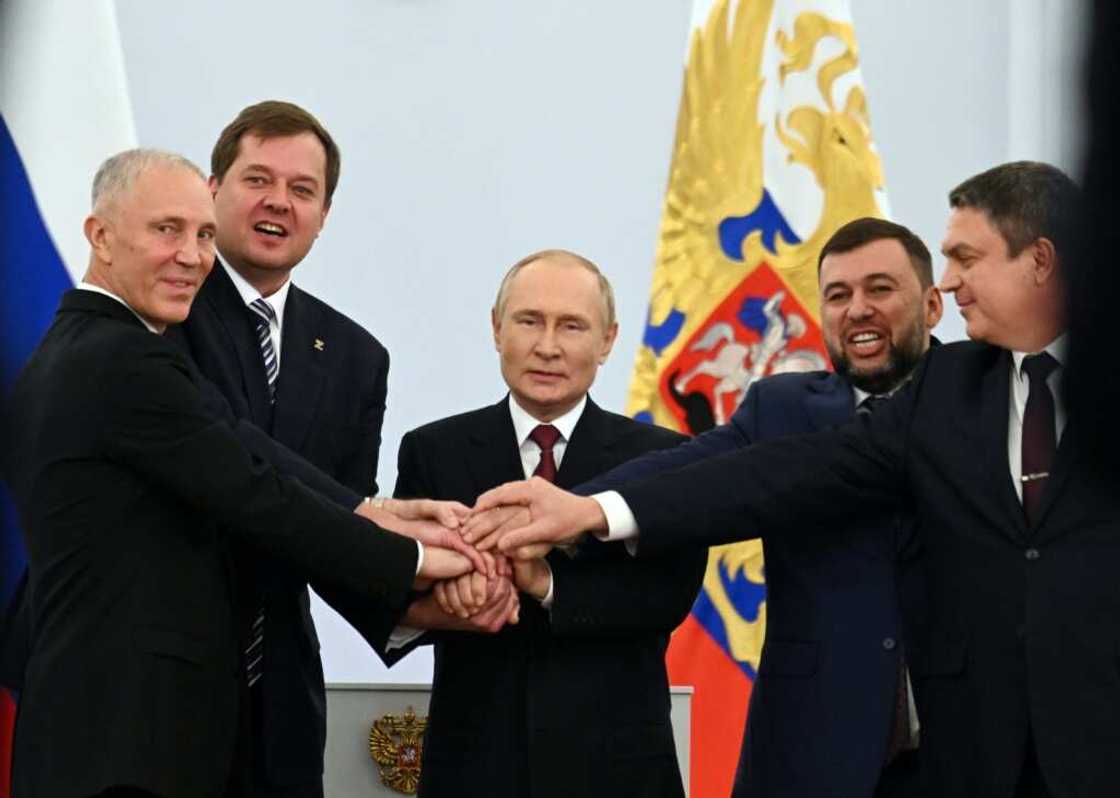 Russian-backed separatist leaders from Ukraine join hands with Russian President Vladimir Putin at a Kremlin ceremony on September 30, 2022