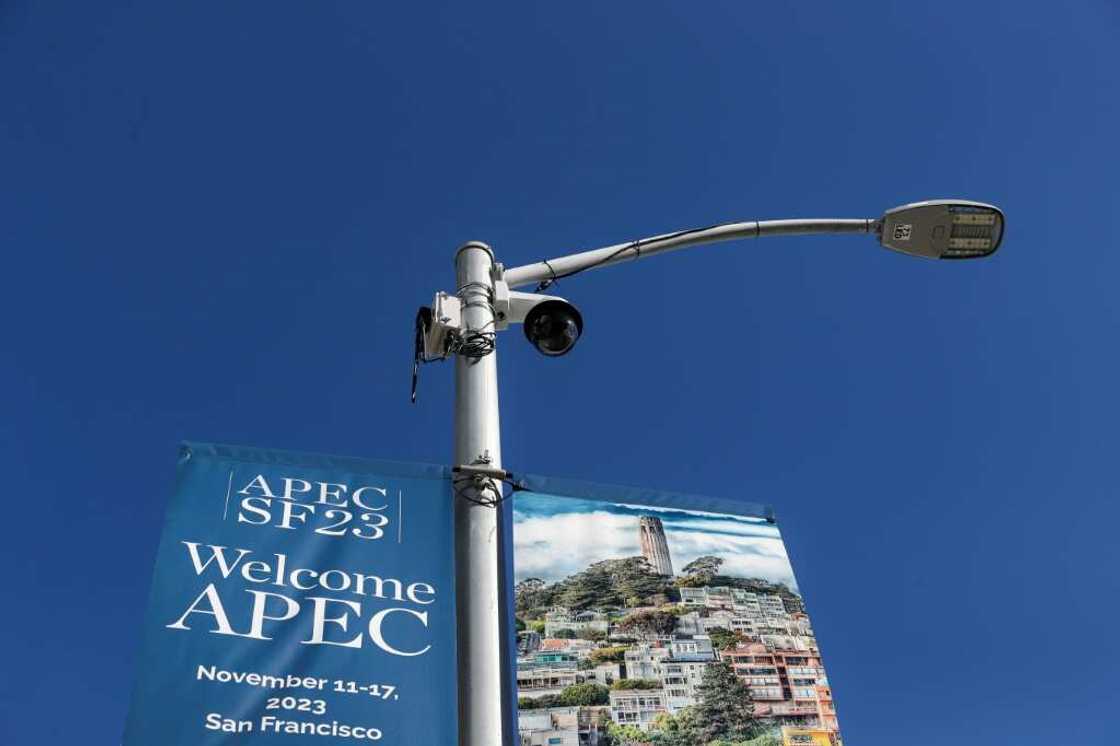 A security camera is seen by a sign announcing the Asia-Pacific Economic Cooperation (APEC) summit as security preparations get under way in San Francisco, California