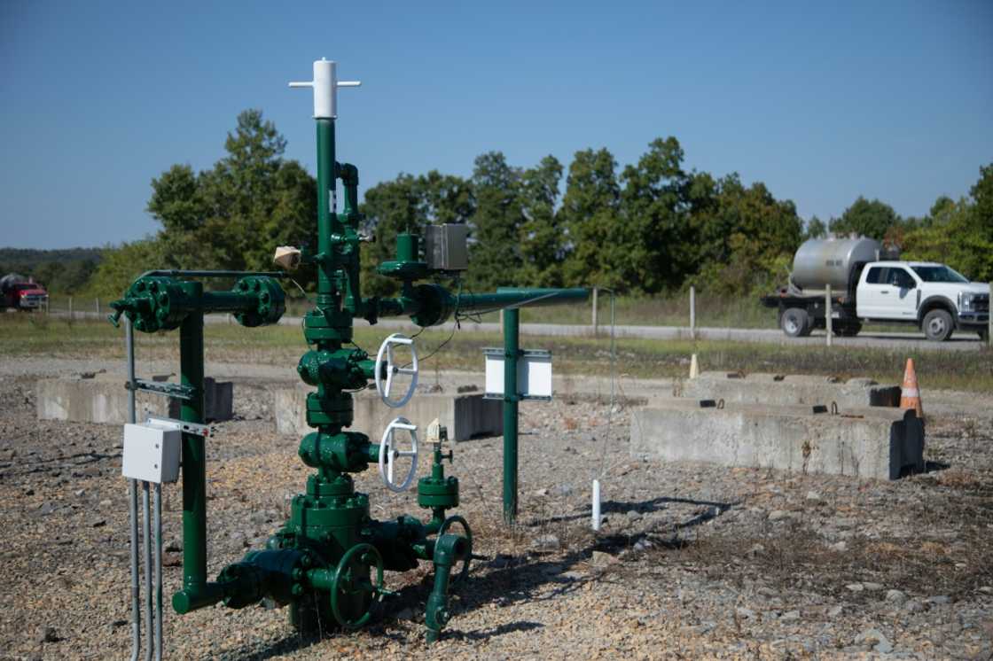 A truck from another well site drives by a Diversified Energy natural gas well site in Franklin Township, Washington County, Pennsylvania