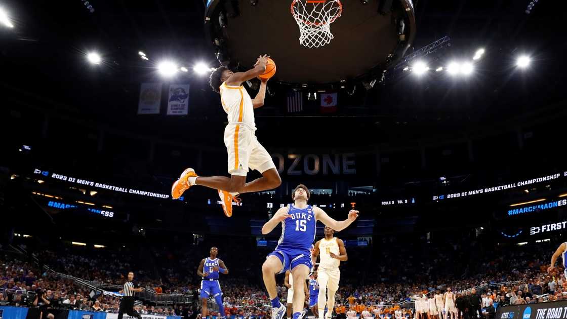 Julian Phillips of the Tennessee Volunteers jumps high to dunk (White).