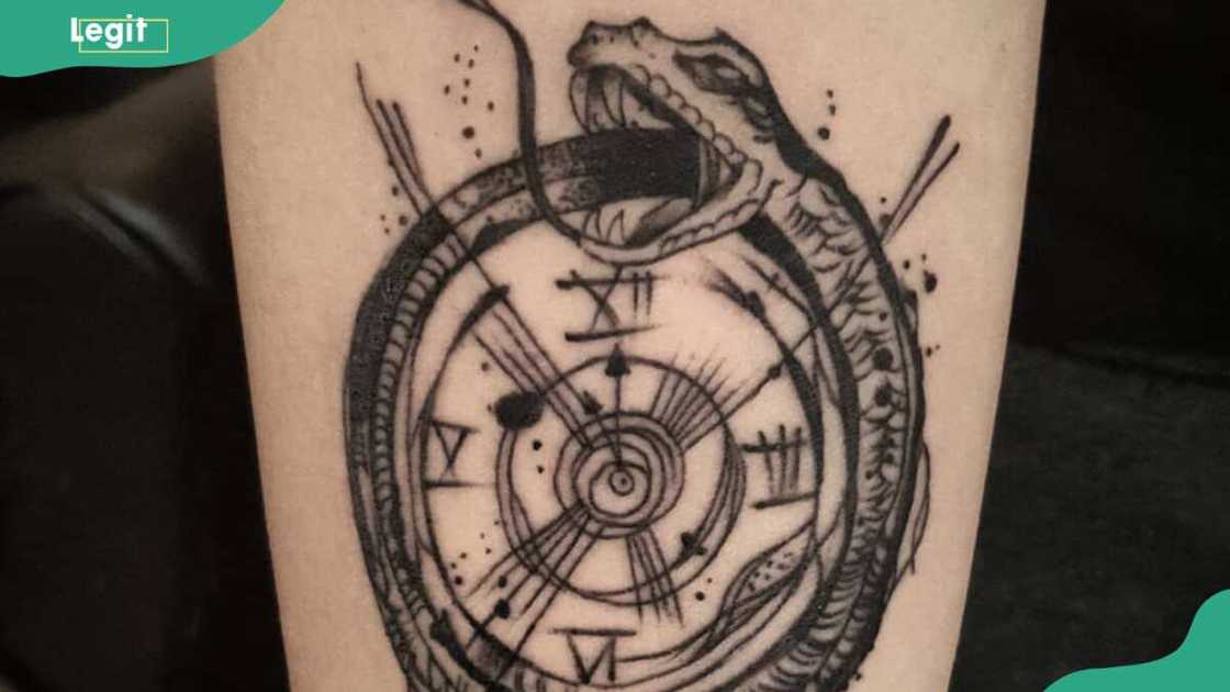 Serpent wrapped around a clock tattoo Serpent wrapped around a clock tattoo