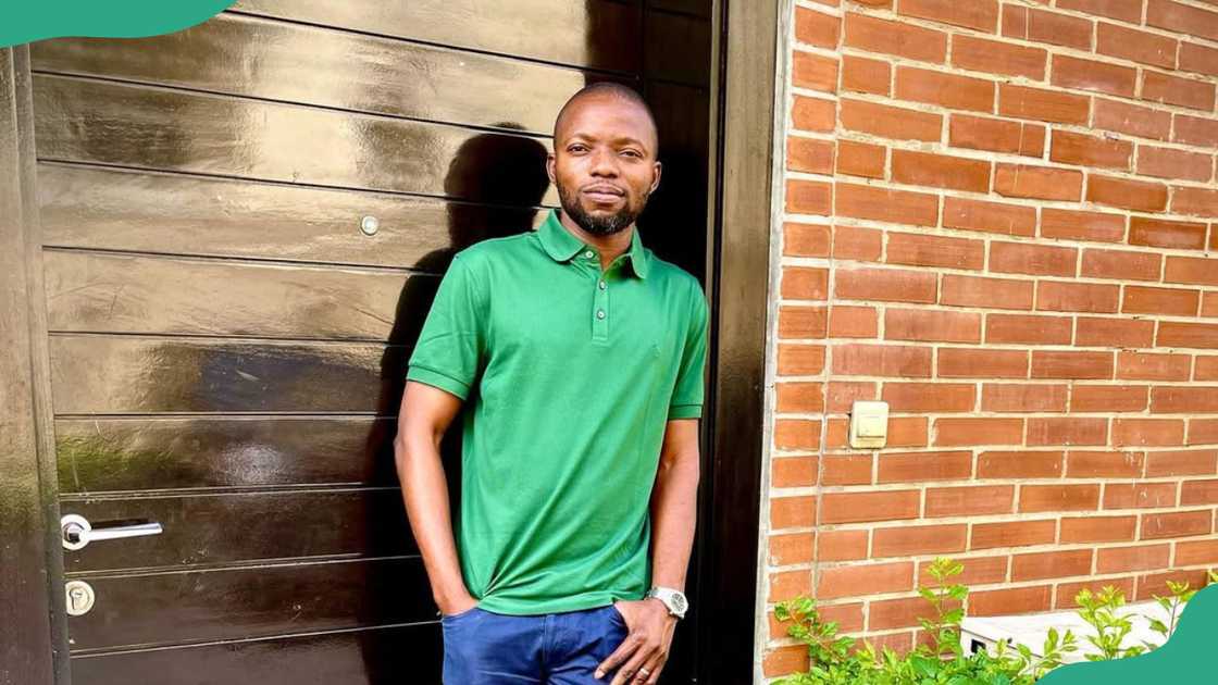 Adekunle Adeniji looks on as he leans on a door Adekunle Adeniji looks on as he leans on a door