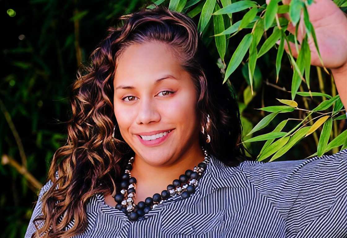 Thavana Monalisa Fatu poses next to a tree. Thavana Monalisa Fatu poses next to a tree.