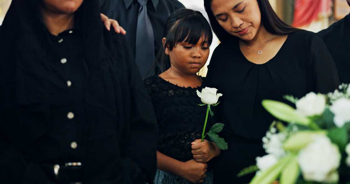 Two women stand apart at a funeral in Lagos. Two women stand apart at a funeral in Lagos.