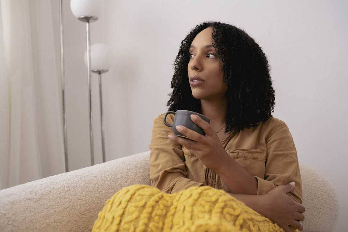 A woman holding a cup A woman holding a cup
