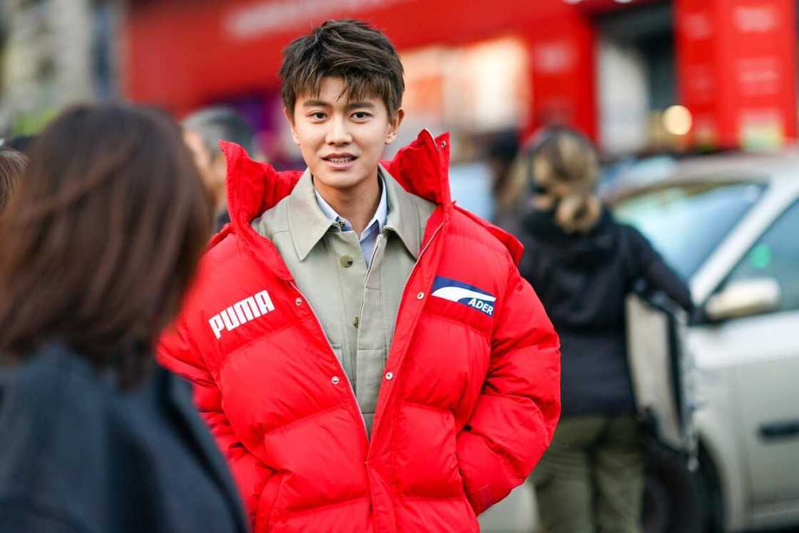 Jialun Ren wears a sand-color shirt, a red Puma puff jacket, outside Paul Smith, during Paris Fashion Week - Menswear Fall/Winter in Paris Jialun Ren wears a sand-color shirt, a red Puma puff jacket, outside Paul Smith, during Paris Fashion Week - Menswear Fall/Winter in Paris
