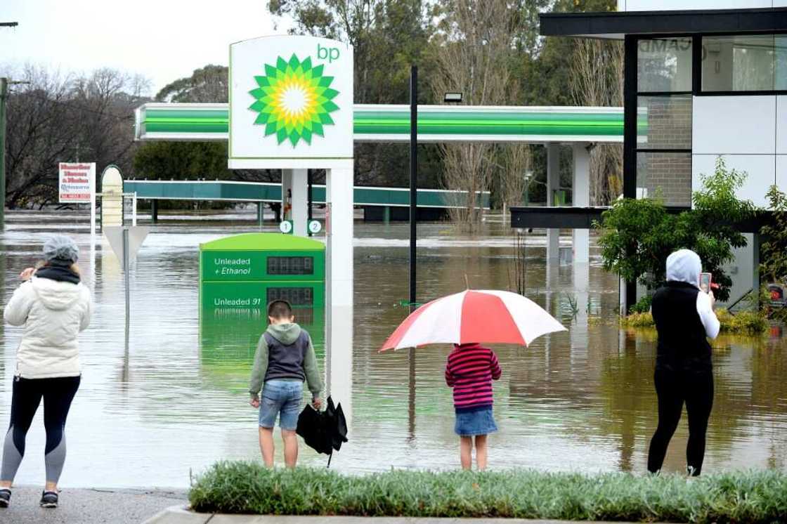 Rapidly rising rivers swamped swathes of rain-lashed Sydney, forcing thousands to flee 'dangerous' floods