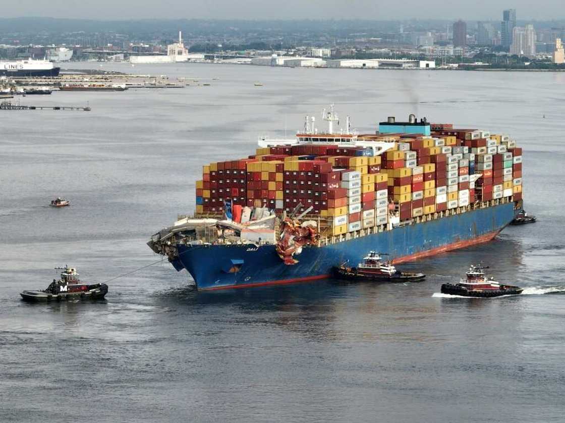 Tug boats maneuver the damaged container ship Dali into the Seagirt Marine Terminal in Baltimore, Maryland Tug boats maneuver the damaged container ship Dali into the Seagirt Marine Terminal in Baltimore, Maryland