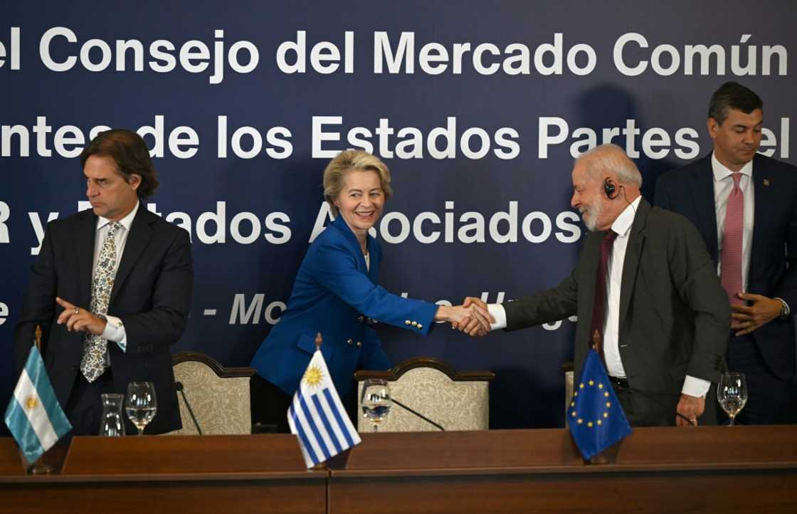 EU chief Ursula von der Leyen (C) says the trade deal is needed in a world headed towards 'isolation and fragmentation' EU chief Ursula von der Leyen (C) says the trade deal is needed in a world headed towards 'isolation and fragmentation'